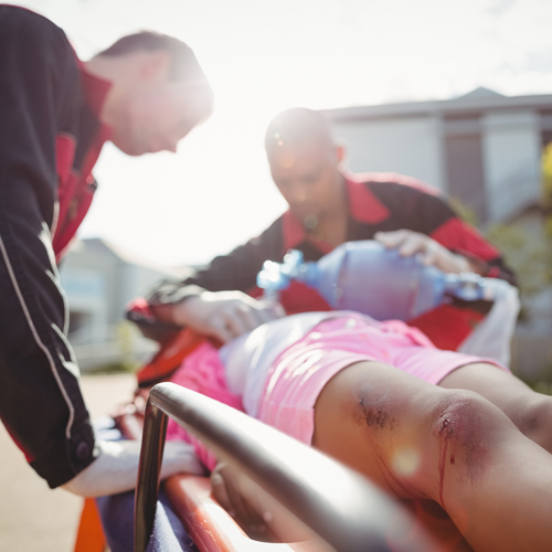 Medical responder giving oxygen to an injured girl