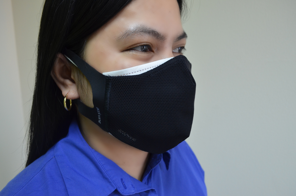 Woman wearing surgical mask and cloth mask